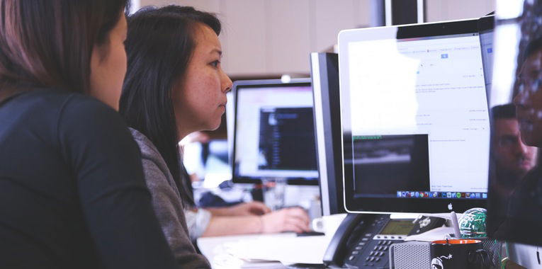 Women looking at a computer monitor